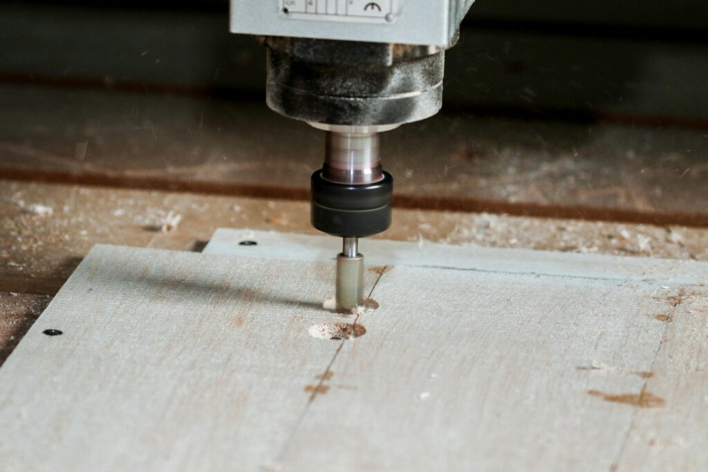 Detailed view of a milling machine cutting wood in a workshop setting.